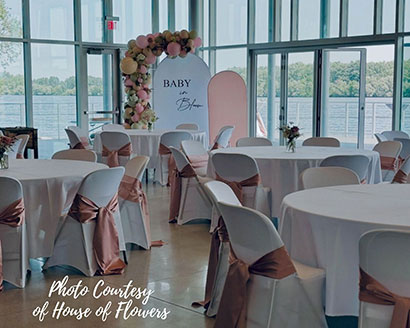 Lakeshore 4 seasons building set up for a baby shower with a pretty balloon arch in the corner
