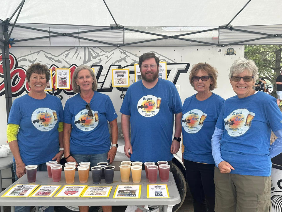 A group of our fabulous volunteers posing for a picture at our Brews by the Bay in Rainbow Park